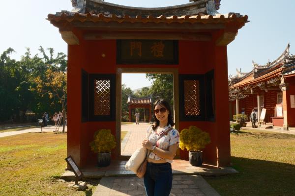 Tammy in front of a gate in the confucius temple.