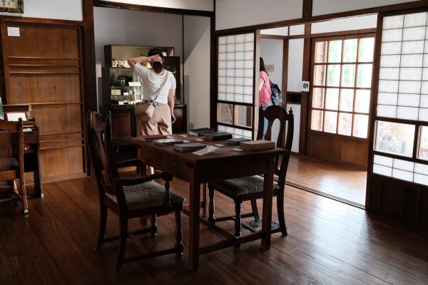 A living room in the Japanese house, with a table and chairs.
