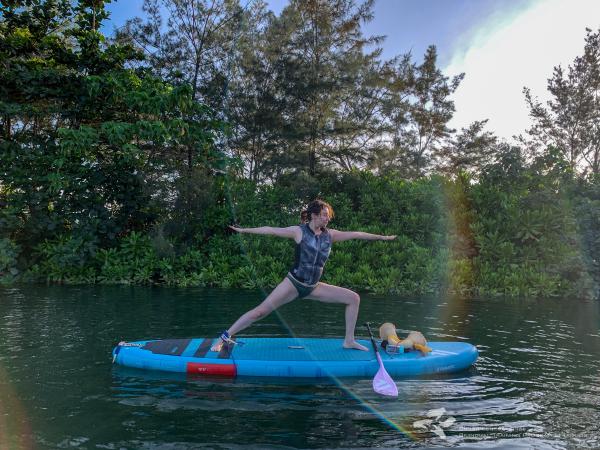 Liana doing a yoga pose on a stand up paddleboard