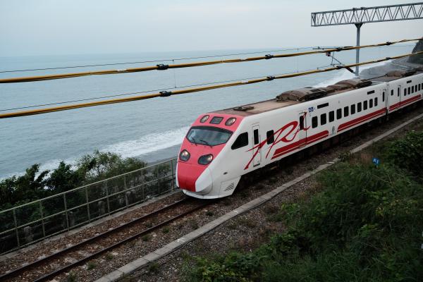 A train with the ocean in the background
