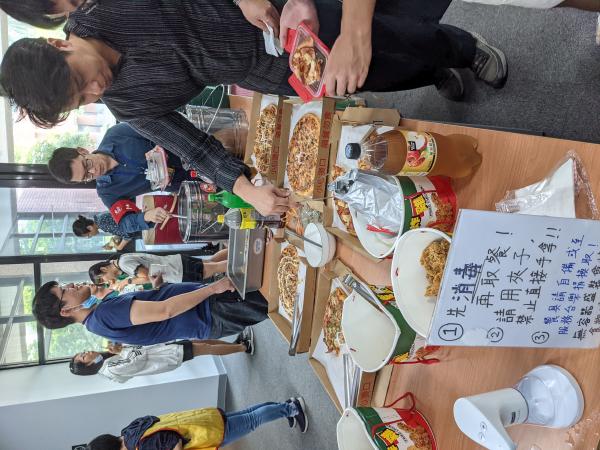 People acquiring pizza.
