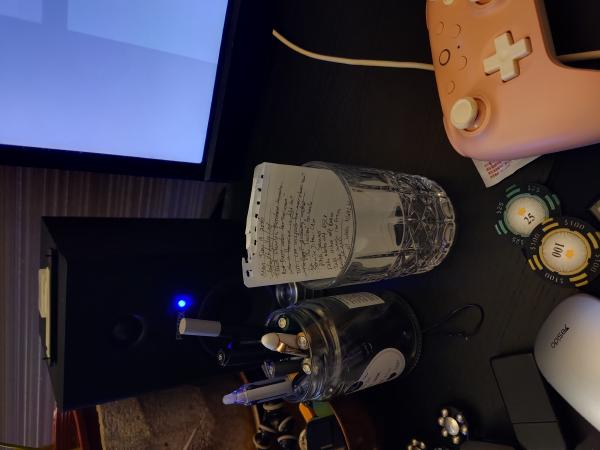 Paper notes in a glass jar on a desk