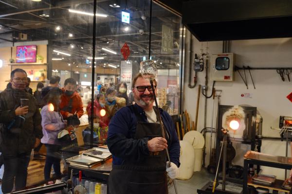 Dad hodling holding the glass blowy tube thing