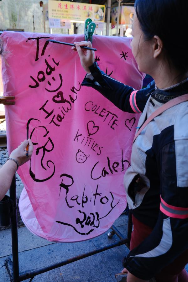 Tammy painting a lantern