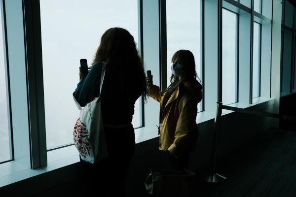 Colette and mom taking pictures out of Taipei 101