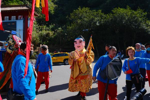 People dressed up in ceremonial costumes near 7-11