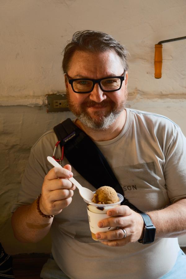Dad eating a iced drink.