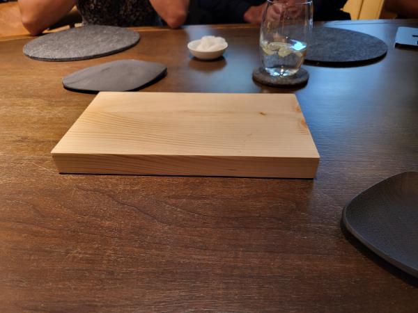 The plank of wood upon which the first bread pairing was served