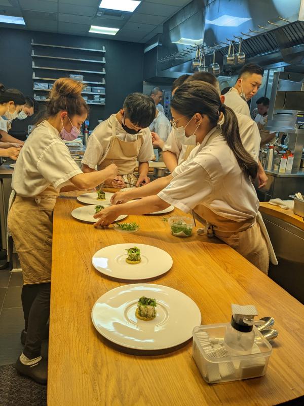 Another image of the kitchen staff plating the monkfish