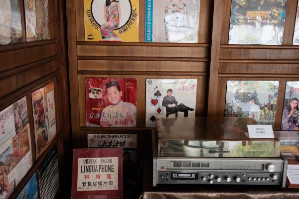 An old record player, and records on the wall.