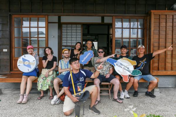 All of us pointing and saying goodbye in front of the Japanese house.