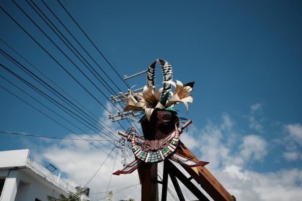 The sculpture on top of the pole