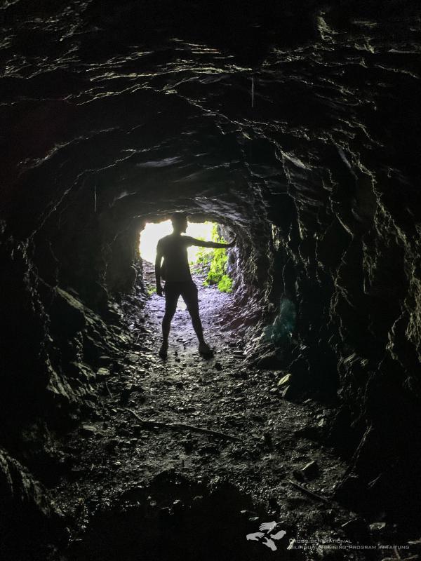 Andrea silhouetted in the cave.