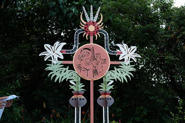 A cross emblazoned with traditional tribal symbols