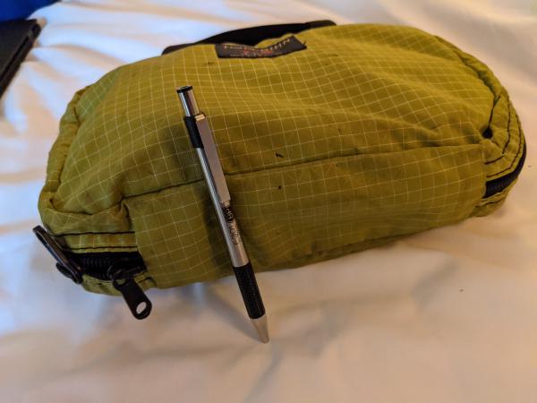 My bathroom bag, packed and closed, with pen for scale.