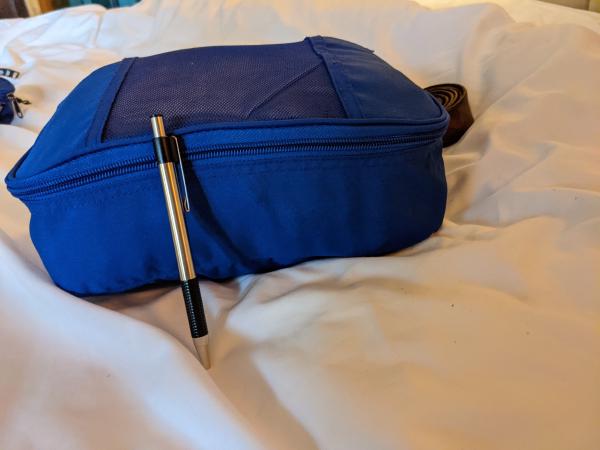 My clothes all packed up, pen for scale.