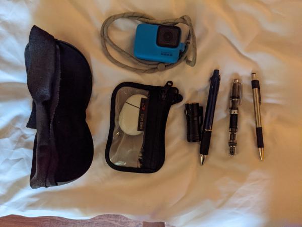 The contents of my front left backpack pocket, partially packed into smaller organizers.