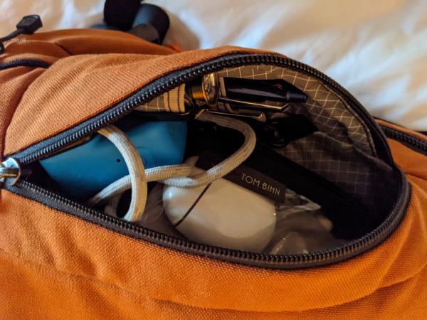 The front left pocket of my backpack, packed and open.