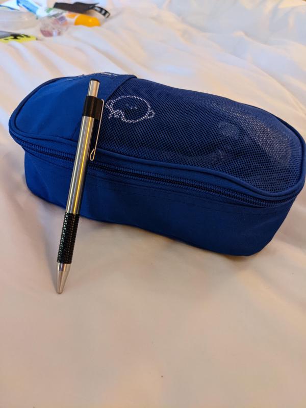 My gym clothes, packed, with pen for scale.