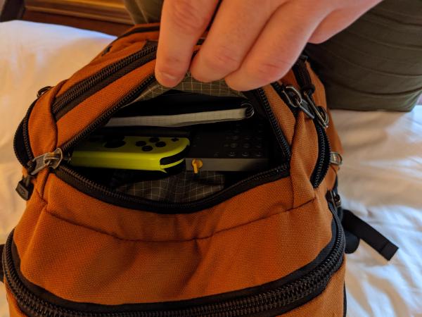 My backpack's top back pocket, packed and open.